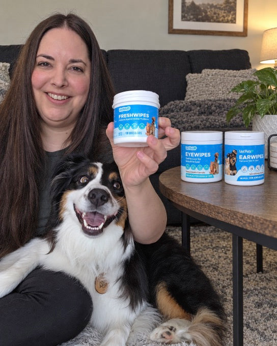 A VetPets member with her dog and the FreshWipes, EyeWipes and EarWipes jars